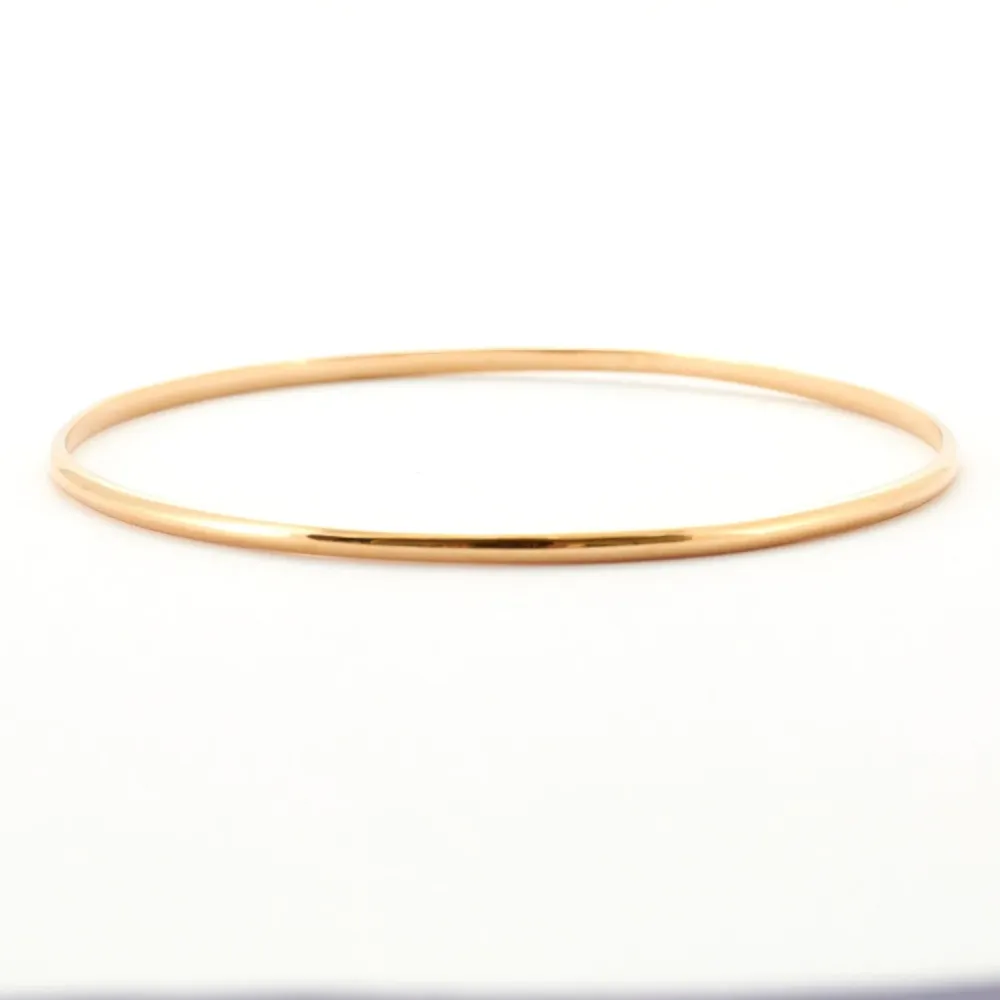 Yellow gold curved half bangle bracelet