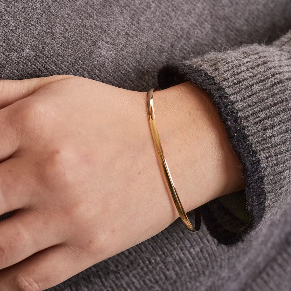 Yellow gold curved half bangle bracelet