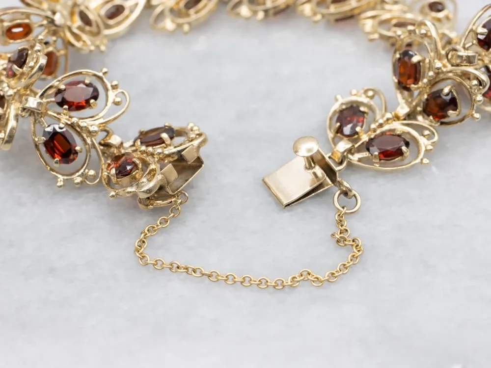 Looping Goud and Garnet Butterfly Link Bracelet