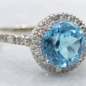 Modern White Gold Blue Topaz and Diamond Halo Ring